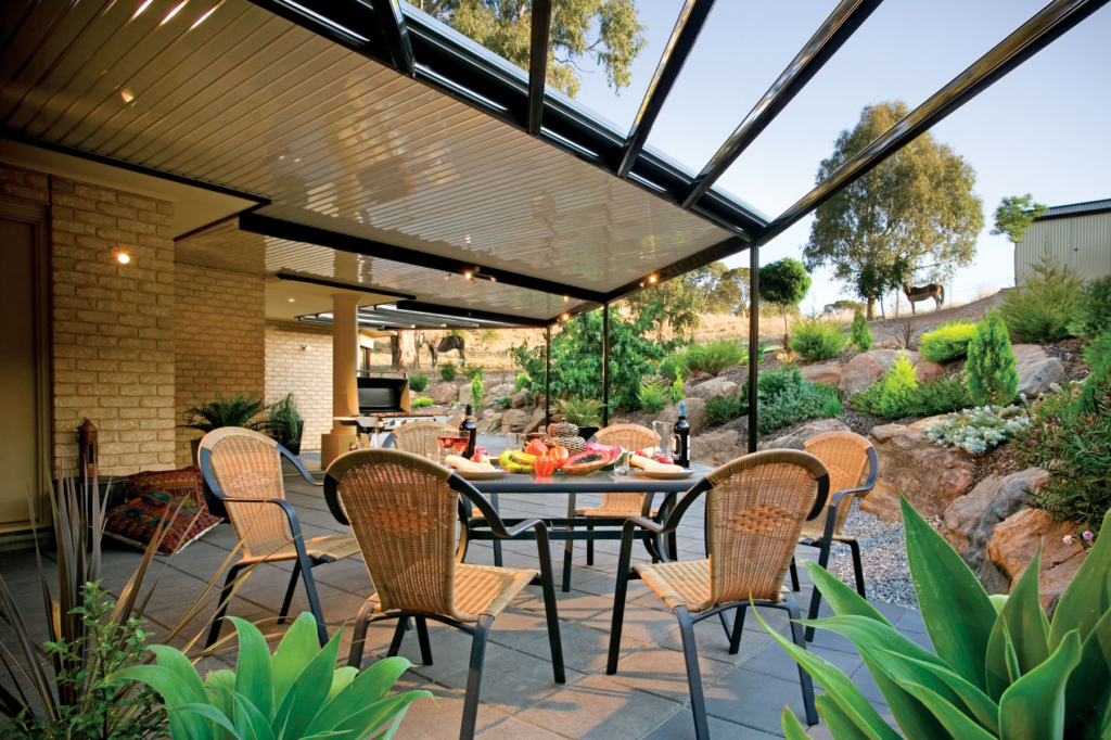 Outdoor patio dining area with a table set for a meal under a covered pergola
