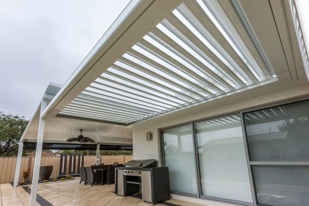 Covered patio with louvered pergola, outdoor dining area, and barbecue grill